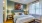 a bed with a blue and white comforter at Jefferson Lake Howel Apartments in Casselberry, FL