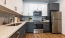a kitchen with white cabinets