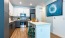 a kitchen with a dining island and chairs at Jefferson Lake Howel Apartments in Casselberry, FL