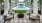 a swimming pool with chairs and a deck with trees and a building in the background at Jefferson Lake Howel Apartments in Casselberry, FL